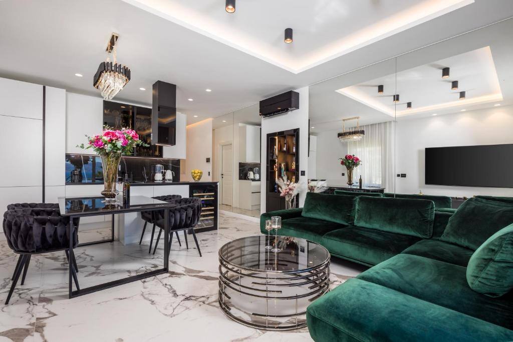 Living room with green sofa and dining table