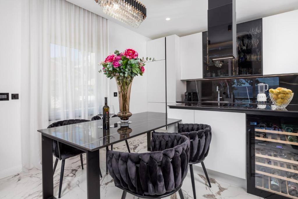 Dining area with black table and kitchen