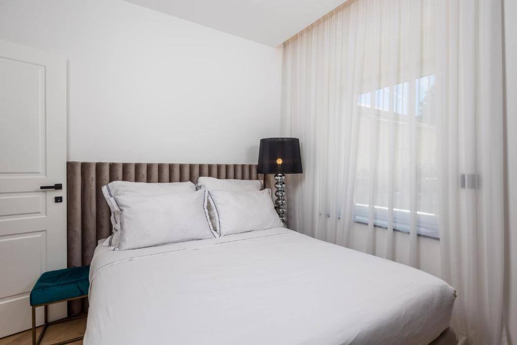 Double bed with upholstered headboard and bright window
