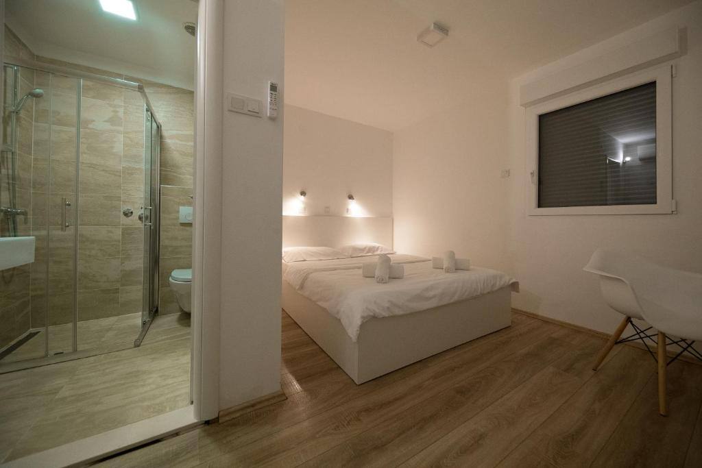 Room with shower and double bed at Rocky Beach Rooms